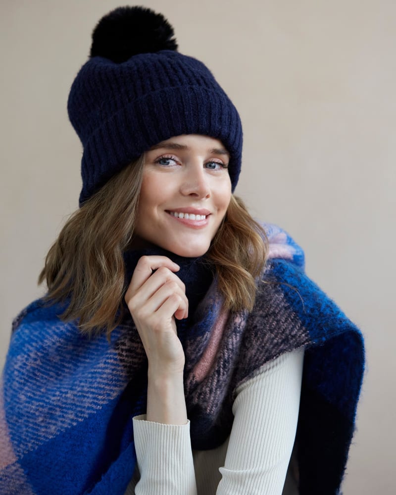 Side of a model wearing a size One Size Pick-A-Pom Winter Knit Hat/Beanie in Navy by Shiraleah. | dia_product_style_image_id:308967